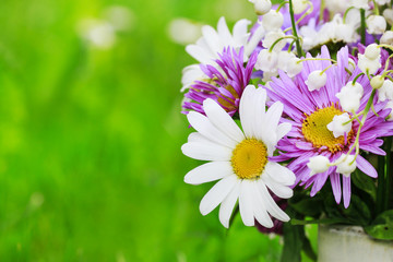Obraz premium Cute bouquet of daisies, carnations, chamomile and lily of the valley flowers.