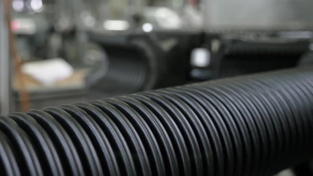 Manufacture of plastic water pipes. Manufacturing of tubes to the factory. The process of making plastic pipes on the machine tool with the use of water and air pressure. Special corrugated forms of