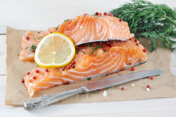 two pieces of salted salmon with lemon and dill