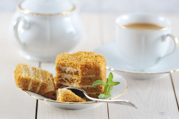 honey cake and a mint leaf on the saucer