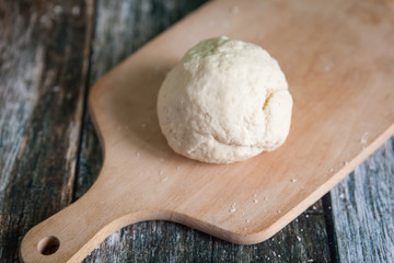 Yeast dough on a wooden cutting board