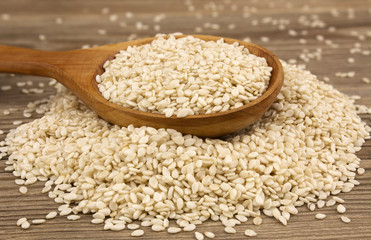 White sesame on wooden background