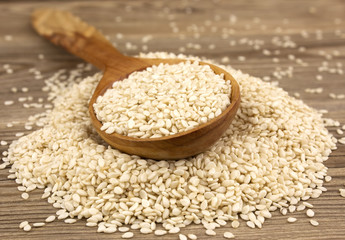 White sesame on wooden background