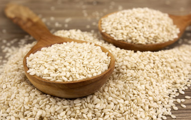 White sesame on wooden background