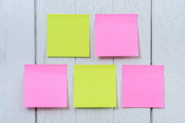 Many colorful sticky note, post note on white wooden vintage background