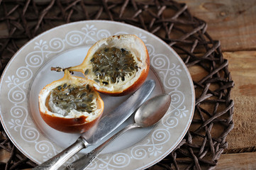 Granadilla or grenadia passionfruit on wooden rustic background