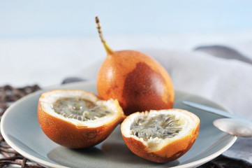 Granadilla or grenadia passionfruit on blue
