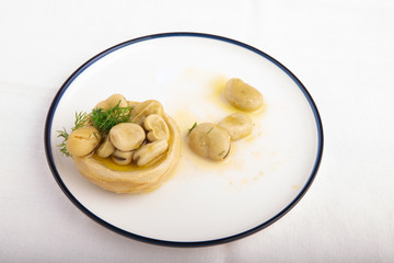 Olive oil artichoke with broad bean, vegetarian food..
