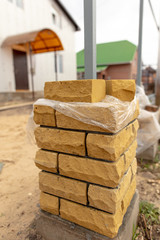 unfinished brick pillar at the construction site