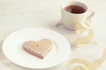 Heart shaped biscuit, a cup of tea. Love concept. Mother's day.
