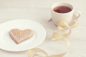 Heart shaped biscuit, a cup of tea. Love concept. Mother's day.