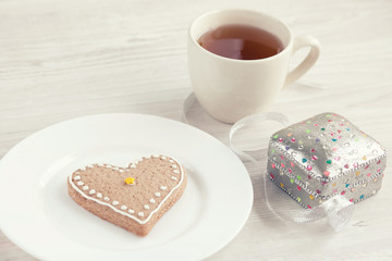 Heart shaped biscuit, a cup of tea and gift box. Love concept. Mother's day.