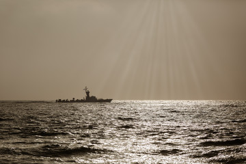 silhouette of a warship at sunset