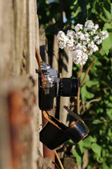 retro. old camera and a wooden fence. Rural landscape.