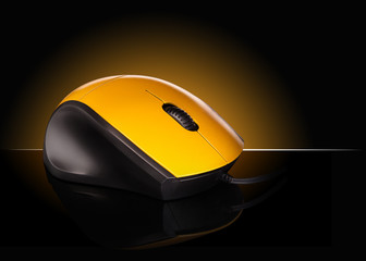 yellow computer mouse on a black background