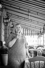 Obraz premium Happy smiling fashionable plus size young woman in modern city life. Life of xxl lady. Concept of positive lifestyle. Pretty stylish girl at city center 