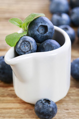 Blueberries in ceramic jug.