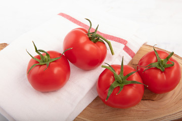 Fresh, ripe tomatoes on wood background  ..
