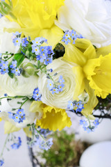 Bouquet of daffodils, forget me not and ranunculus flowers.