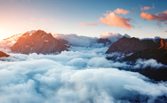 Fototapeta Creamy fog covered the glacier Marmolada. Location place Val di Fassa valley, passo Sella, Dolomiti, Italy.