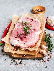 Fresh raw pork chops with spices and herbs