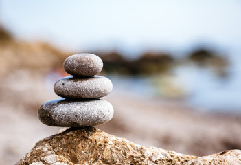 Stones balance, pebbles stack over blue sea. Picturesque and gorgeous scene.