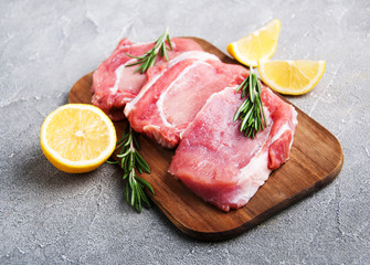 Fresh raw pork chops with spices and herbs