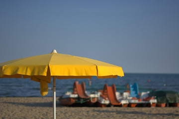 A yellow umbrella on the beach