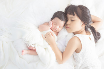 cute big sister with new newborn baby