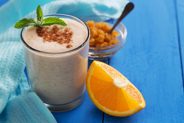 Orange milkshake with cinnamon and mint