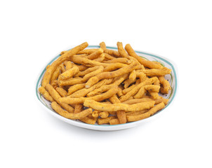 Sev is a popular Indian snack food consisting of small pieces of crunchy noodles made from chickpea flour paste, which are seasoned with turmeric, cayenne, and ajwain before being deep-fried in oil.