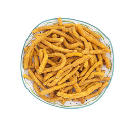 Sev is a popular Indian snack food consisting of small pieces of crunchy noodles made from chickpea flour paste, which are seasoned with turmeric, cayenne, and ajwain before being deep-fried in oil.