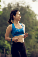 Fototapeta premium young sports woman runner running on road