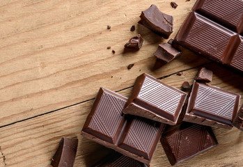 close up of chocolate pieces on old wooden table