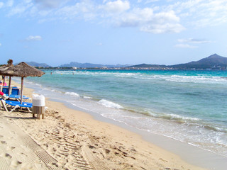 Beach view, beautiful turquoise ocean, beach with sunbeds and sun umbrellas,