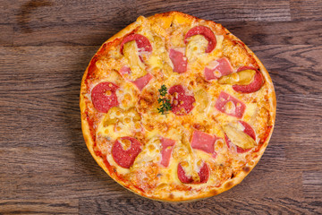 Pizza with ham and sausages