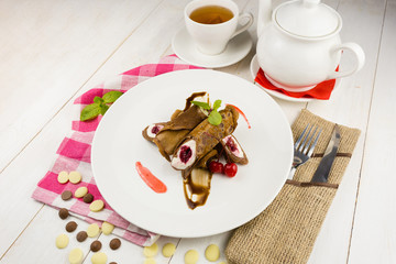 Sweet chocolate pancakes with cherries