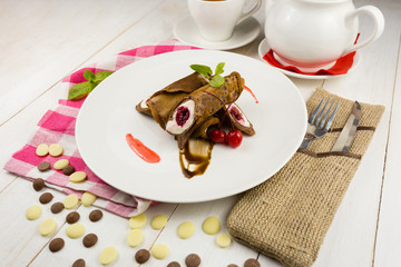 Sweet chocolate pancakes with cherries