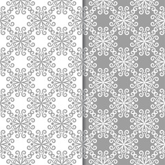 White and gray floral backgrounds. Set of seamless patterns