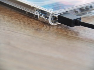 The drive is connected to a notebook computer on a wooden desk. With the concept of keeping information in the trade, it is important to the business.