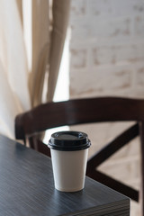 paper Cup with coffee are on the table, the concept of coffee with you