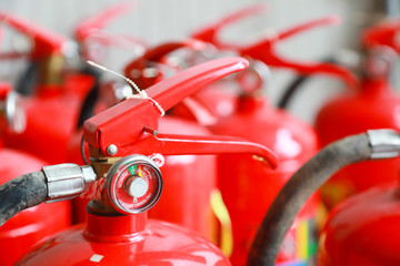 Red tank of fire extinguisher.