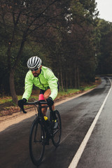 Fototapeta premium Sportsman riding bicycle on country highway