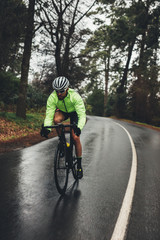 Fototapeta na wymiar Cyclist training on a rainy day