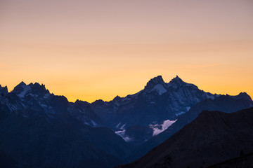 Fototapeta na wymiar High altitude alpine landscape at dawn with first light glowing the majestic high peak of the Barre des Ecrins (4101 m), France.