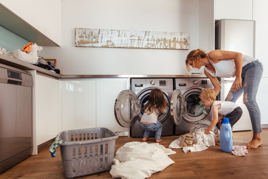 Family doing laundry together at home
