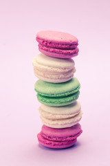 Sweet and colourful french macaroons or macaron on light purple background