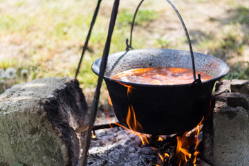 Gulyas stew boiling in a cauldron