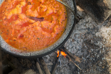 Gulyas stew boiling in a cauldron