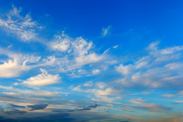 Obraz premium Background of transparent gray dramatic clouds in a blue sky.